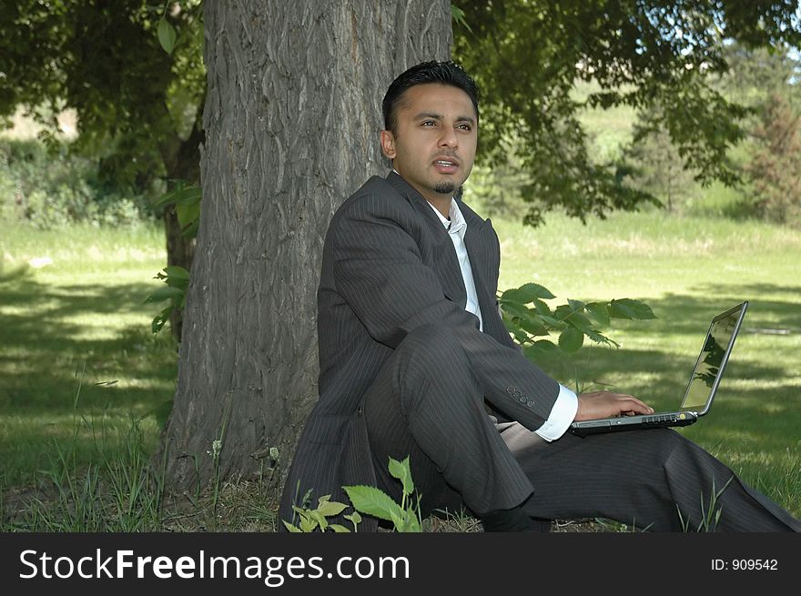 Businessman in a park with a laptop. Businessman in a park with a laptop.
