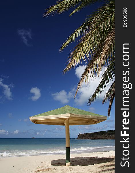 Parasol with palm leaf at a caribbean beach. Parasol with palm leaf at a caribbean beach