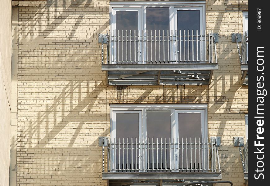 City building balconies with staircase reflections. City building balconies with staircase reflections