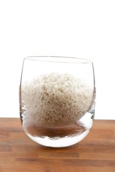 Coarse Grey Sea Salt In Glass On Wooden Table Royalty Free Stock Image