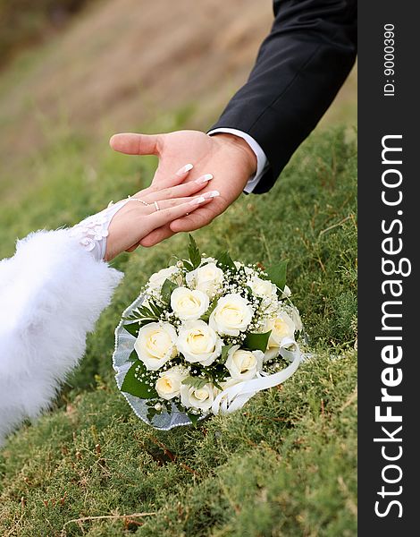 Two hands over flower bouquet. Two hands over flower bouquet