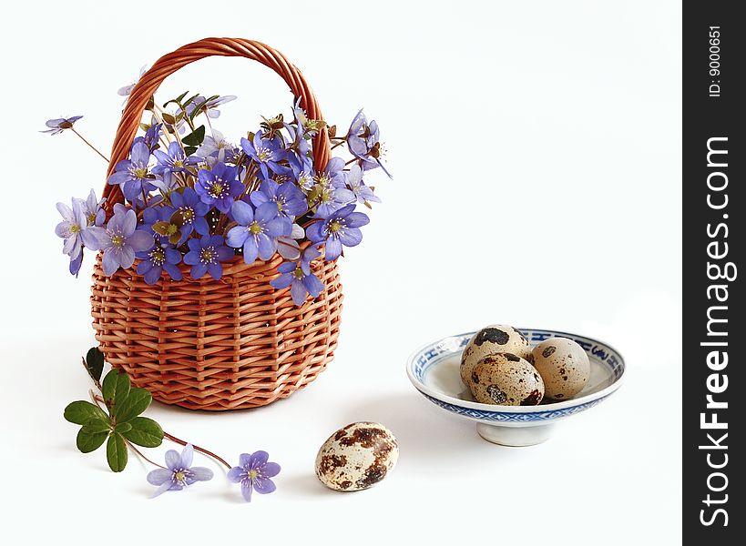 Eggs and violets in basket