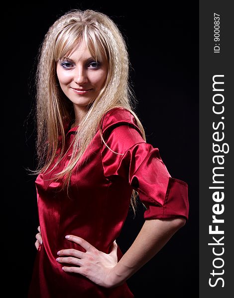 Charming girl in red on a black background