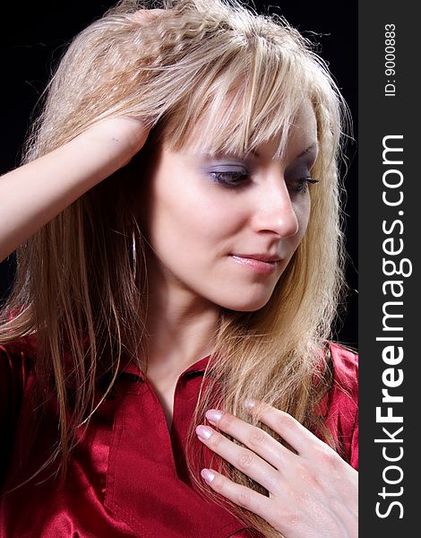 Charming girl in red on a black background