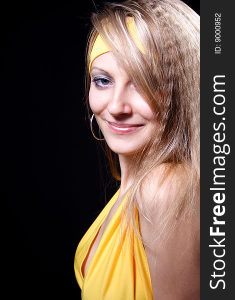 Charming girl in yellow on a black background