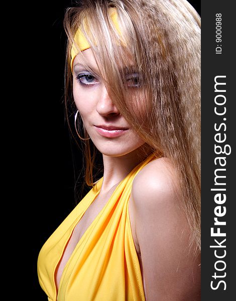 Charming girl in yellow on a black background