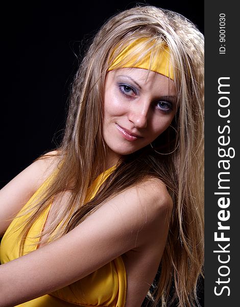 Charming girl in yellow on a black background