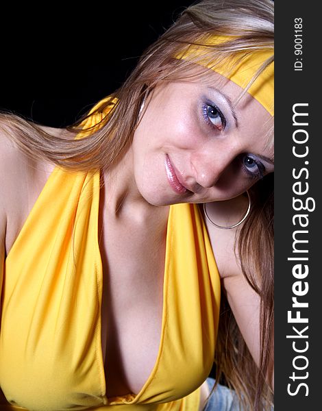 Charming girl in yellow on a black background