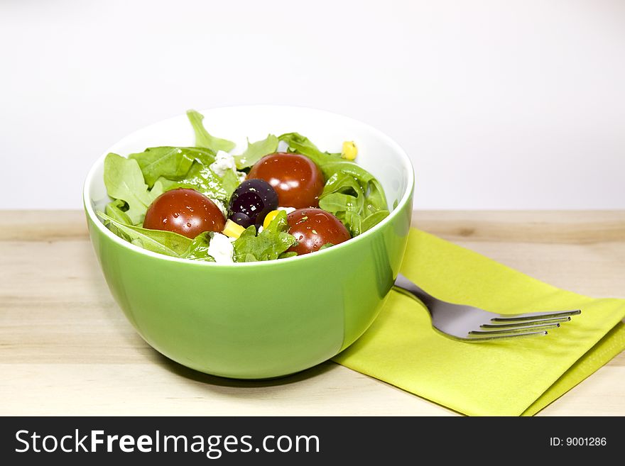 A bowl with salad and tomatoes