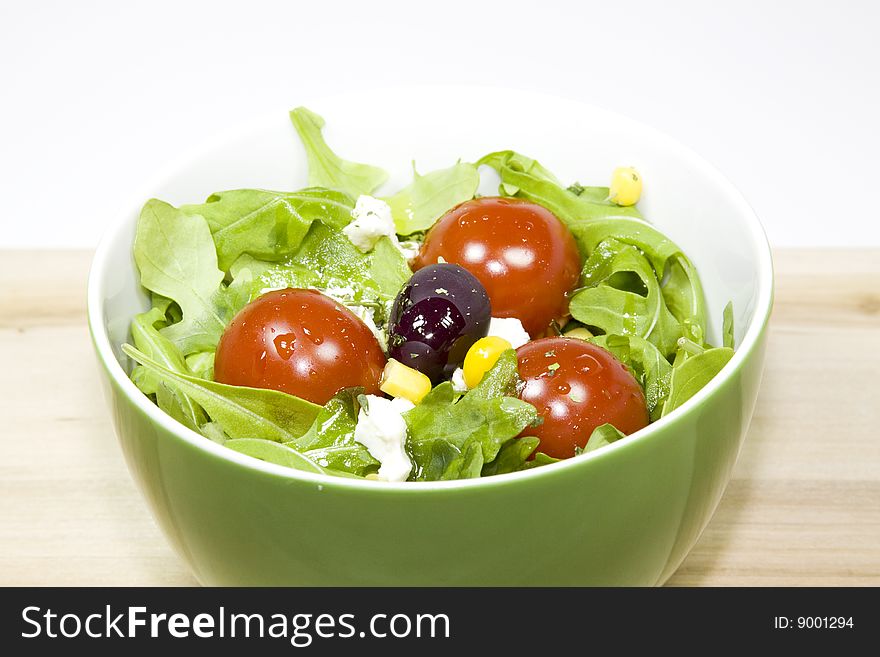 A bowl with salad and tomatoes