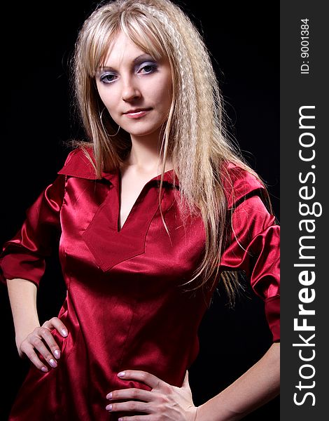 Charming girl in red on a black background