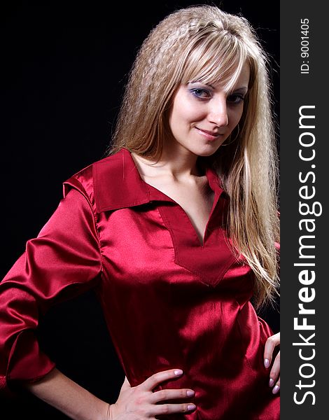 Charming girl in red on a black background