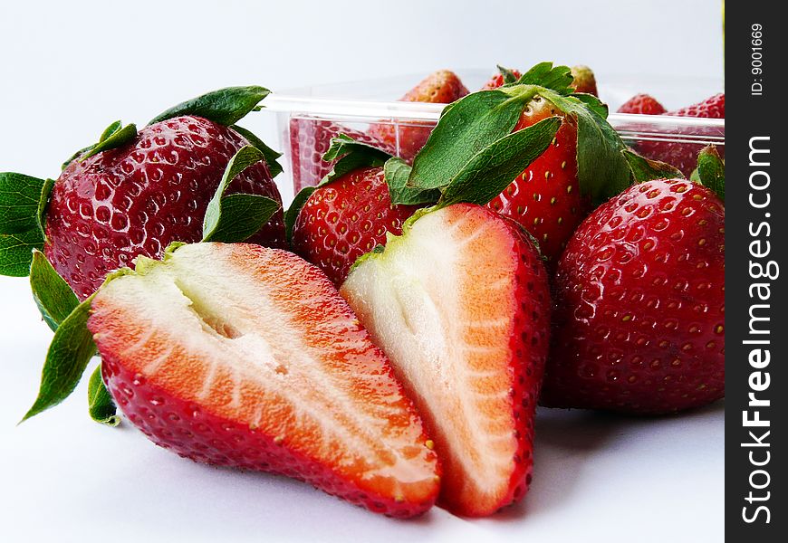 Some strawberries in and out bowl