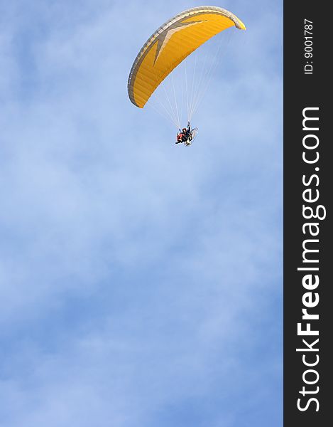 Orange paramotoring with blue sky