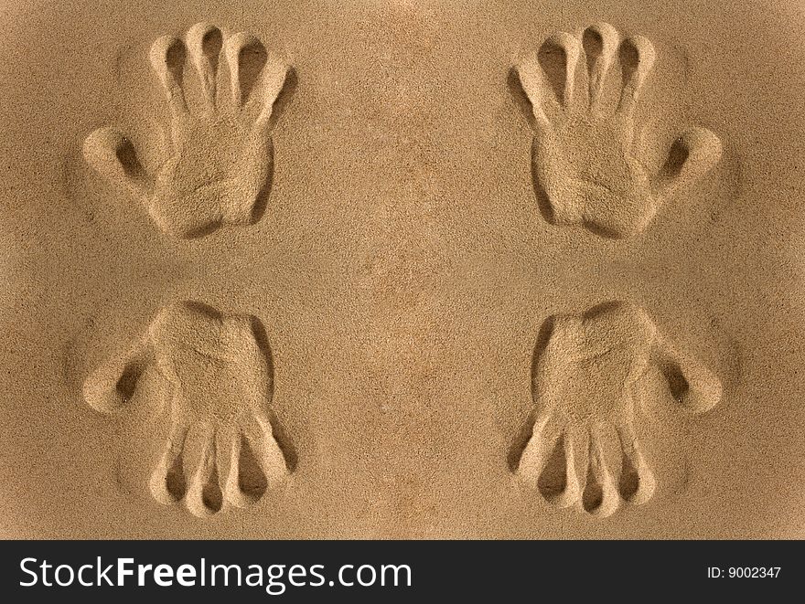 Close-up of hand imprints in sand