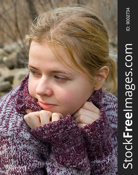 A portrait close-up of the girl in sweater. A portrait close-up of the girl in sweater.