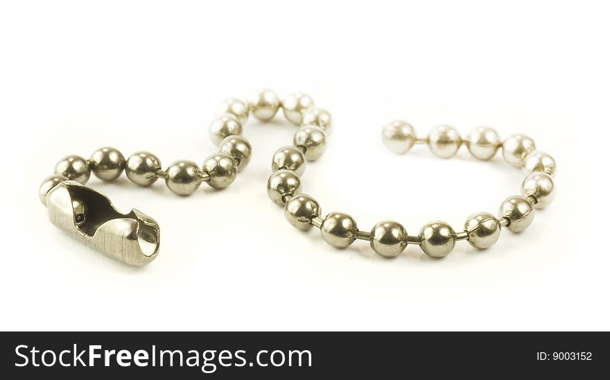 Short small ball chain arranged as snake isolated on white background. Short small ball chain arranged as snake isolated on white background