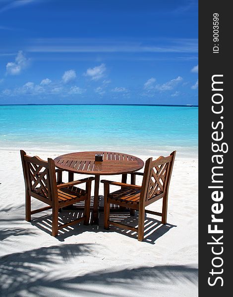 Table and chairs on exotic beach. Table and chairs on exotic beach