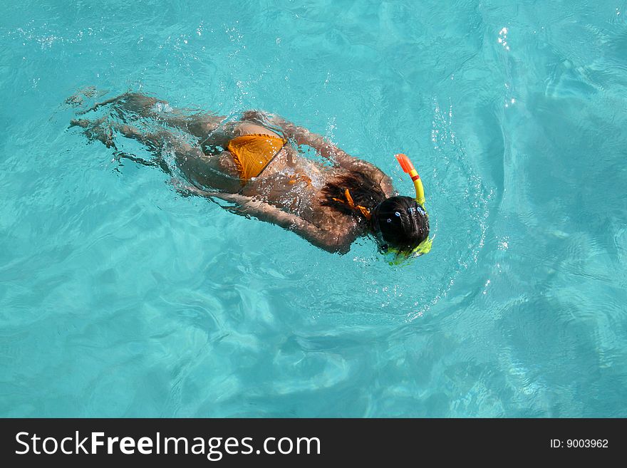 The girl snorkeling in blue watersnorkeling