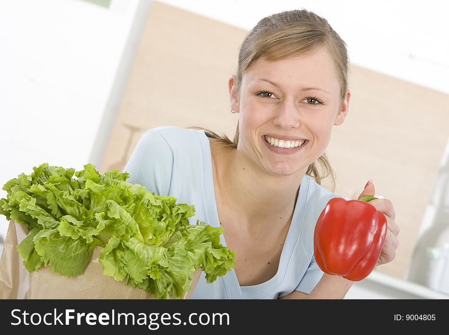 Beautiful young woman making vegetarian vegetable salad. Beautiful young woman making vegetarian vegetable salad