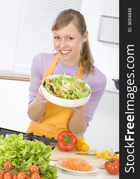 Beautiful young woman making vegetarian vegetable salad. Beautiful young woman making vegetarian vegetable salad