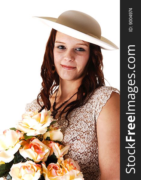 Beautiful lady in a beige long dress and hat standing in the studio with yellow roses in her arm smiling, for white background. Beautiful lady in a beige long dress and hat standing in the studio with yellow roses in her arm smiling, for white background.