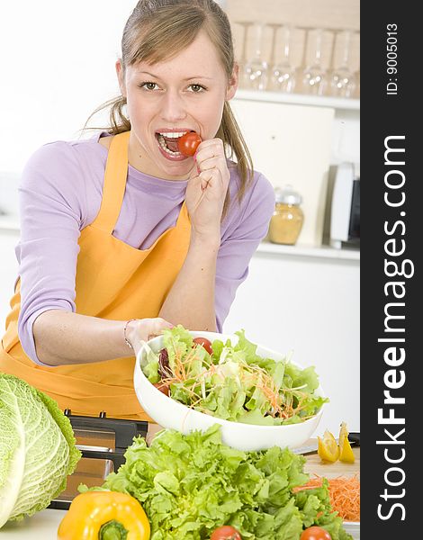 Beautiful young woman making vegetarian vegetable salad. Beautiful young woman making vegetarian vegetable salad