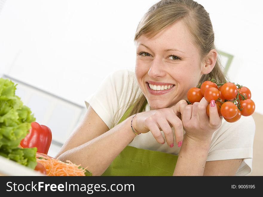 Beautiful young woman making vegetarian vegetable salad. Beautiful young woman making vegetarian vegetable salad