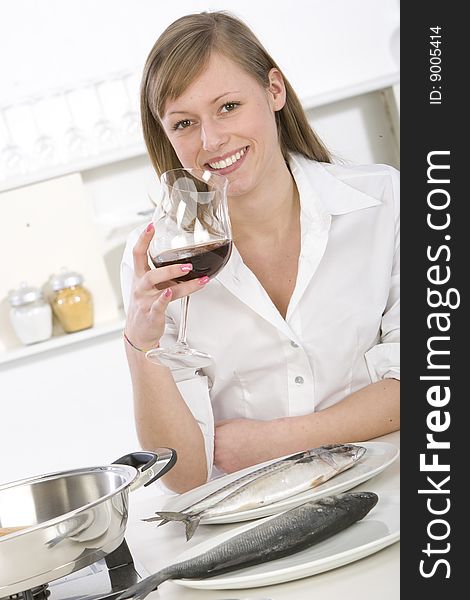 Women in kitchen with glass of wine. Women in kitchen with glass of wine