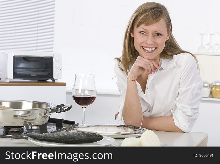 Women in kitchen with glass of wine. Women in kitchen with glass of wine