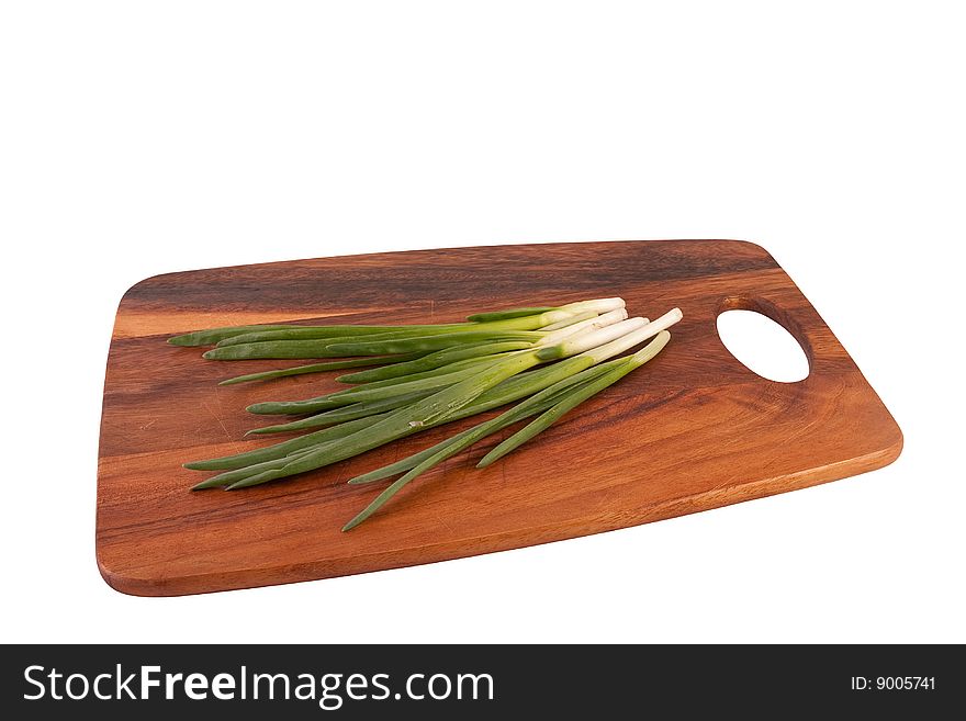 Spring onions on cutting board. Isolated on white.