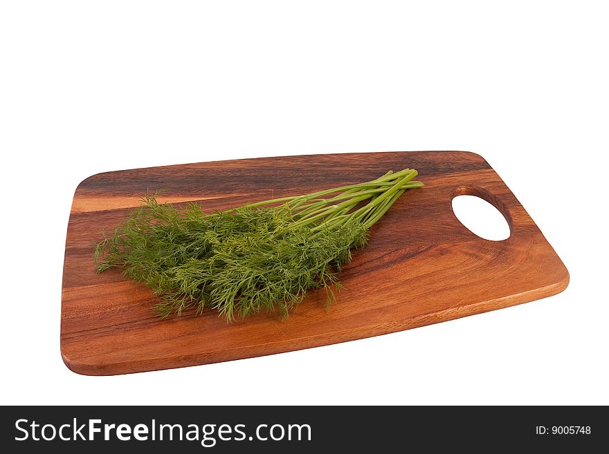 Dill on cutting board. Isolated on white.