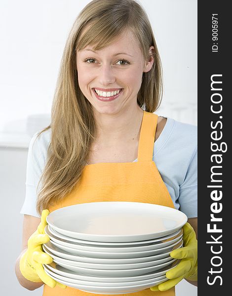 Woman Cleaning Dishes in the kitchen