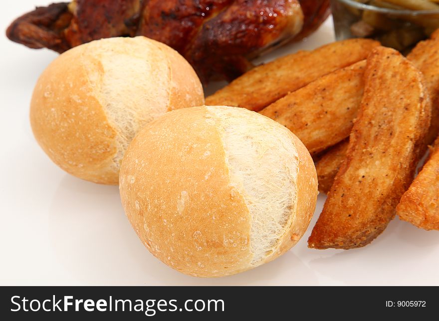 Close up Chicago Rolls with potato wedges, chicken, green beans in background.