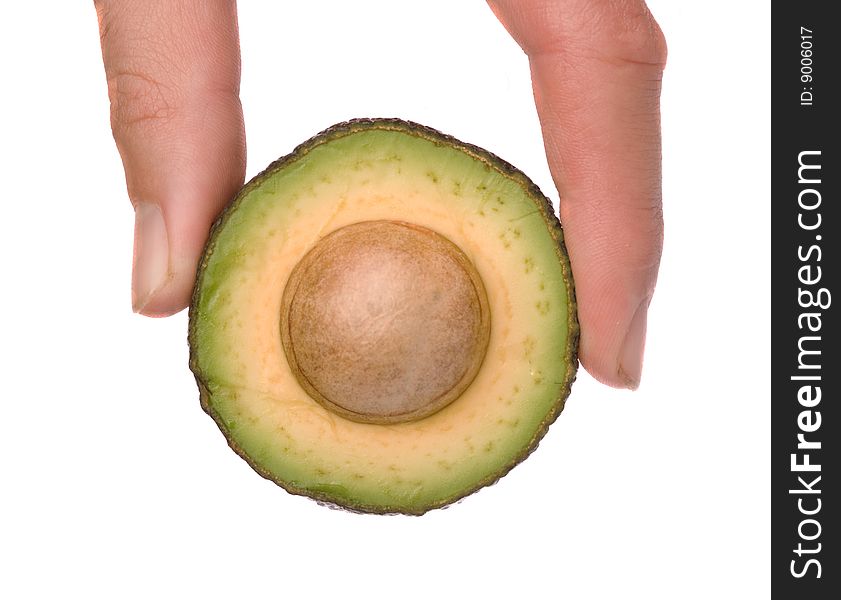 Hand Holding Section Of Acocado
