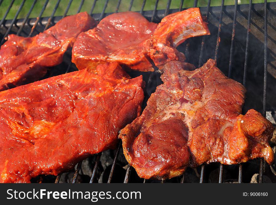 Pieces of meat on the charcoal grill. Pieces of meat on the charcoal grill.