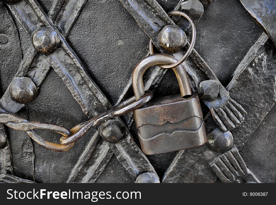 Old padlock on iron door