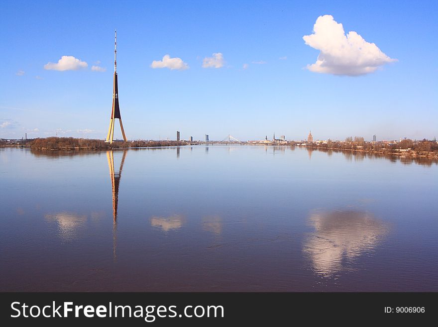 Panorama of Riga with reflection of clouds in water. Panorama of Riga with reflection of clouds in water