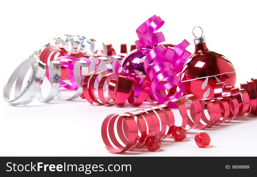 Brightly colored Christmas ornaments and curly ribbon. Brightly colored Christmas ornaments and curly ribbon