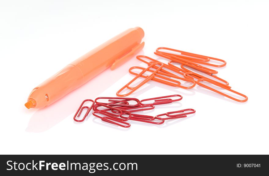 Orange highlighter pen with orange and red paper clips. Orange highlighter pen with orange and red paper clips