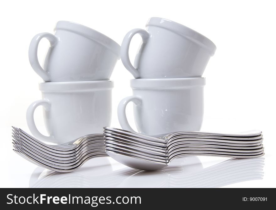 Cups and silverware stacked and ready for serving. Cups and silverware stacked and ready for serving