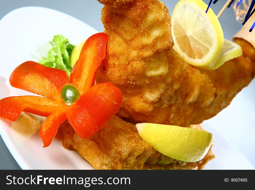 Fried dish with vegetables on white plate