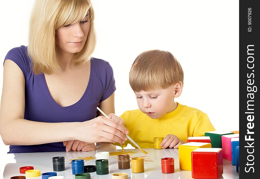 Young mum draws with the son paints. Young mum draws with the son paints