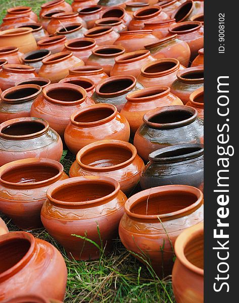 Lots of clay pots on the grass. Lots of clay pots on the grass