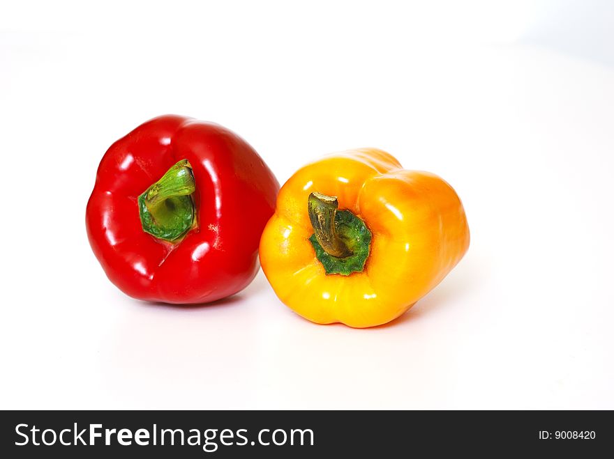 Red and yellow pepper on white background