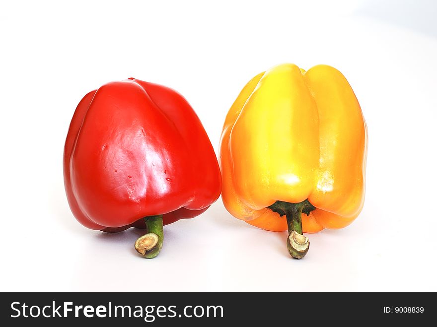 Red and yellow pepper on white background