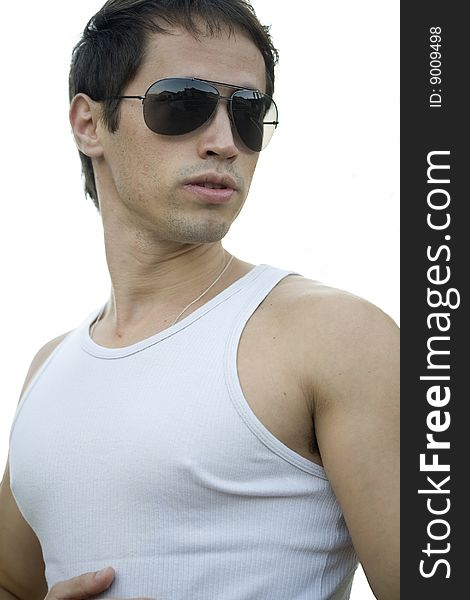 A young male model from Brazil in outdoors photograph,with aviator sunglasses. A young male model from Brazil in outdoors photograph,with aviator sunglasses.