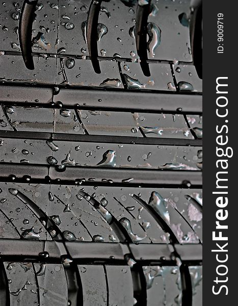 Close-up Of Car Tire With With Water Drops