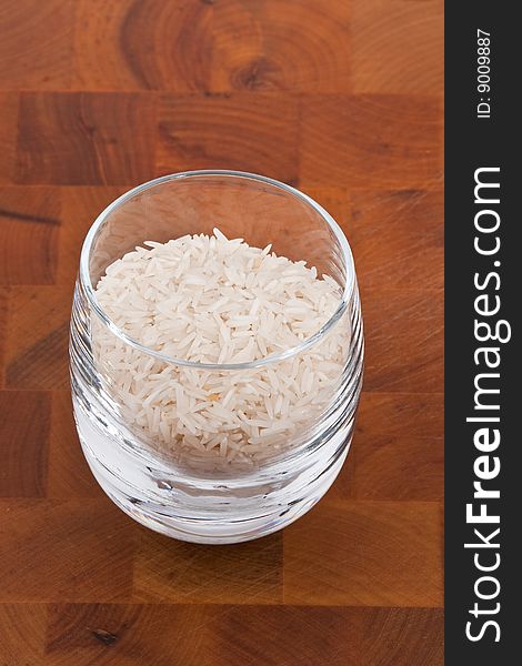 Basmati rice in glass on wooden table