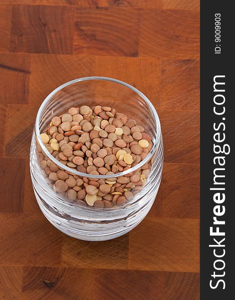 Lentils in Glass on wooden table